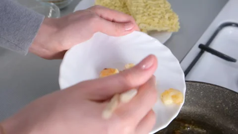 Woman chef hands cooking adding shrimps from frying pan with chopsticks. Stock Footage 311890097