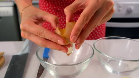 Woman chef hands separating egg yolk from egg white cooking on kitchen. Stock Footage 313001770