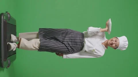 Woman Chef Holding A Dish While Walking On Treadmill In The Green Screen Stock Footage 249622604