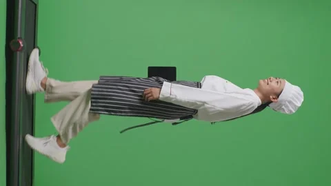 Woman Chef Holding A Tablet While Walking On Treadmill In The Green Screen Stock Footage 249622901