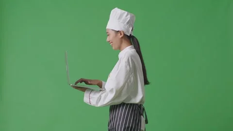 Woman Chef Holding A Tablet While Walking In The Green Screen Background Studio Stock Footage 249623203