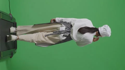 Woman Chef Talking On Smartphone While Walking In The Green Screen Stock Footage 249623732