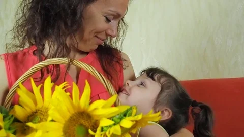 A woman with a child with sunflower flowers. Stock Footage