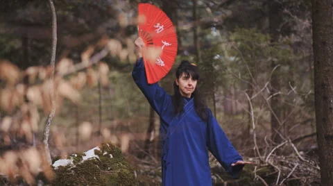 Woman with Chinese fan standing in pose | Stock Video | Pond5