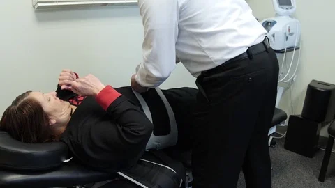 A woman on chiropractic table getting ready for a chiropractic treatment Video stock 126600417