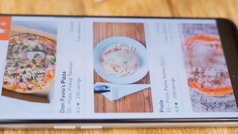 A Woman Chooses to Order Italian Food Pizza and Pasta in an Online Store Using h Stock Footage 129828251
