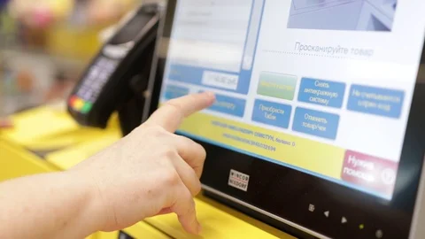 Woman chooses a payment method on a touch monitor in a supermarket Stock Footage 113700619