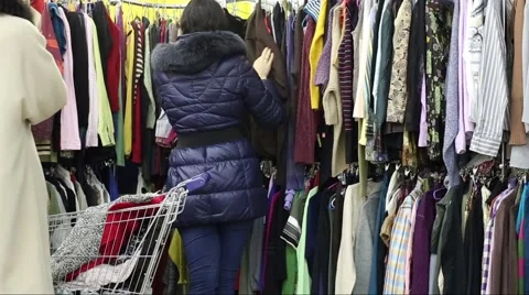 Woman Chooses Pullovers In The Market Stock Footage 45858853