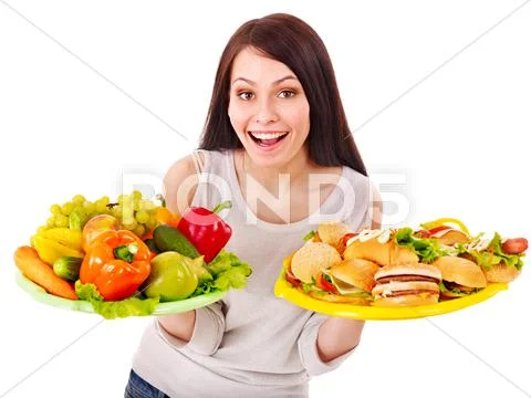Woman choosing between fruit and hamburger. Stock Photos