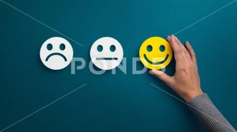 Woman choosing happy smiley face emotion on blue Stock-Fotos