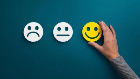 Woman choosing happy smiley face emotion on blue Stock Photos