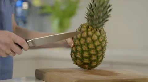 Woman chopping pineapple Stock Footage 22064319