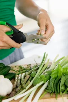 Woman chopping vegetables in the kitchen Stock Photos
