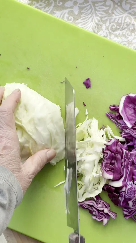 A woman chops cabbage vertical Stock Footage 308592959