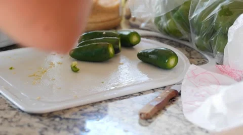 A woman chops jalapenos for fresh salsa Stock Footage