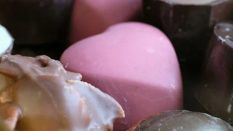 Woman chosing assorted chocolate from box tasty dessert background. Close up Stock Footage 102420331
