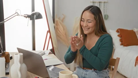 Woman clapping hands at laptop in studio during a remote study session at a.. Stock Footage 339130912