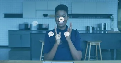 Woman clapping in kitchen, generating chat bubbles for marketing tapping tablet Stock Photos
