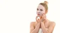 The woman with a clean mask touching a face on the white background. slow motion 4k or 4k+ Resolution