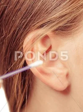 Woman Cleaning Ear With Cotton Swabs Closeup