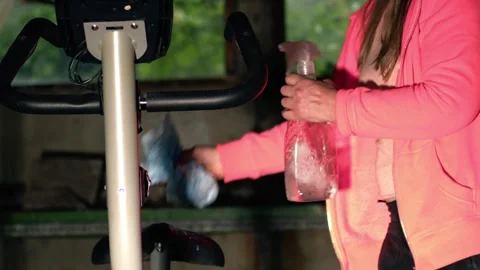 Woman cleaning exercise machine Stock Footage 283568420