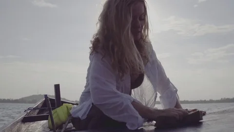 Woman cleaning fishing boat Stock Footage 75699324