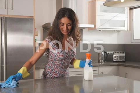 Woman Cleaning Kitchen Counter