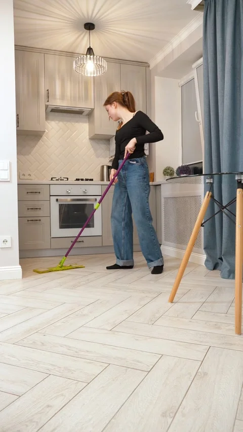 Woman cleaning kitchen floor with mop Stock Footage 309782848