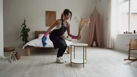 Woman cleaning table using rag and diffuser at home Slow motion Stock Footage 232446359