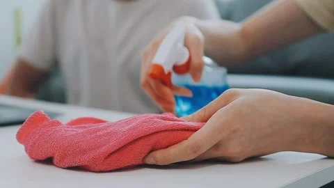 Woman cleaning table using rag and diffuser at home. Stock Footage 271704857
