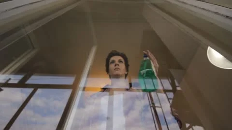 Woman cleaning window Stock Footage 12269876