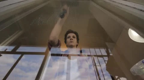 Woman cleaning window time lapse Stock Footage