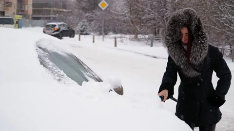 Woman Wearing Winter Fashion In Heavy Snowfall Or Snowstorm Stock