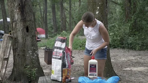 Woman Cleans Grill for Dinner while Camping Stock Footage
