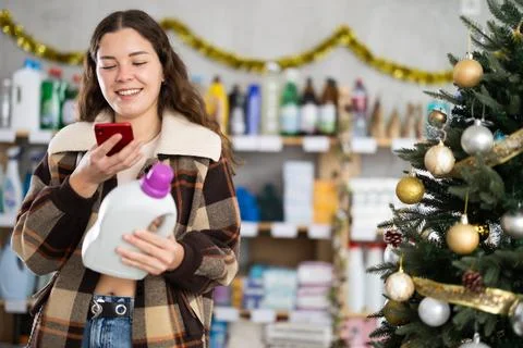 Woman client, by scanning QR code, gain access to information about liquid Stock Photos