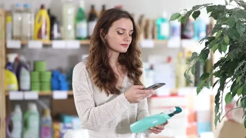 Woman client scans QR code on package and downloads promo code to purchase tile Stock Footage 313096828