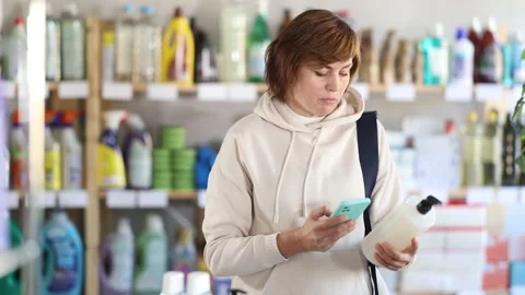 Woman client scans QR code on package and downloads promo code to purchase Stock Footage 315025708