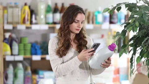 Woman client scans QR code on package and downloads promo code to purchase Stock Footage 332737531