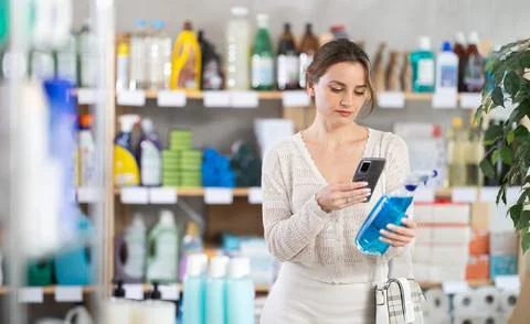 Woman client scans QR code on package and downloads promo code to purchase tile Stock Photos