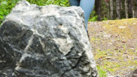 Woman climbing and jumping over a rock in forest Stock Footage 83181353