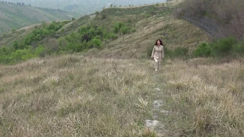 Woman climbing hill Stock Footage