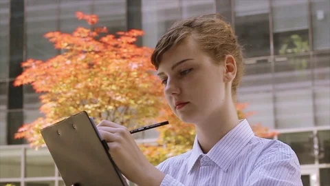 Woman with Clipboard Taking Notes Stock Footage 89634119