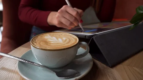 Woman Closeup Using iPad Pro in Cafe 4K. Female hands drawing on Tablet. Stock Footage 112395477