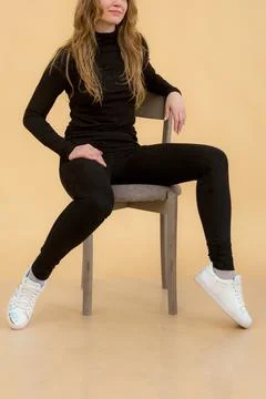 A woman in clothes on the background in the studio, fitting clothes Stock Photos