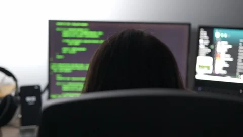 Woman coding cybersecurity in python places headphones on stand and leaves Stock Footage 242508633
