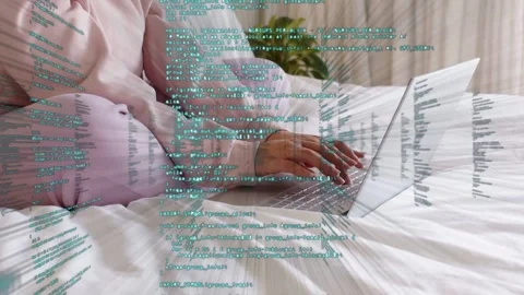 Woman coding on laptop, causing green code overlay to intensify, forming tunnel Stock Footage 333602495