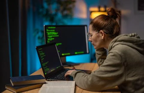 Woman coding programs at night Stock-Fotos