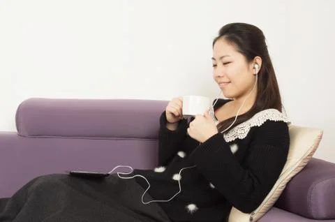 The woman coffee and music Stock Photos