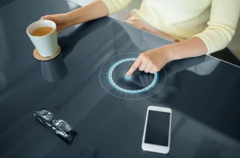 Woman with coffee using interactive panel Stock Photos