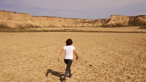 Woman collapsing in the desert. Desolation Stock Footage 80661137
